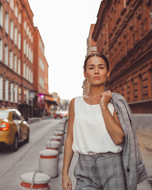 the girl is walking around the city