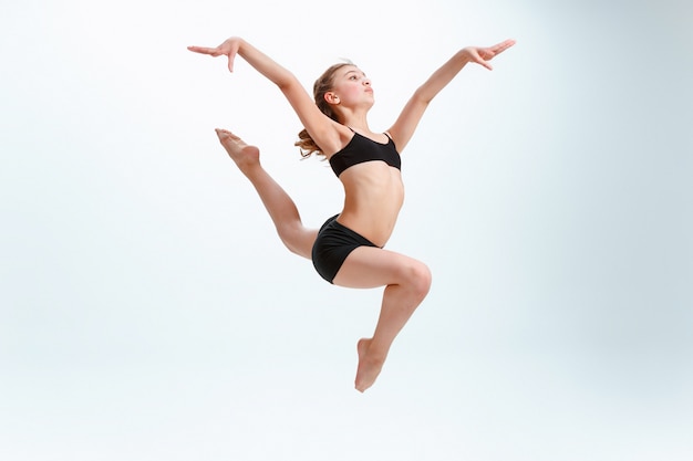The girl jumping as modern ballet dancer