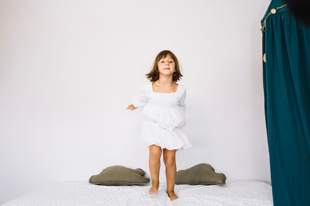 Free photo girl jumping on bed