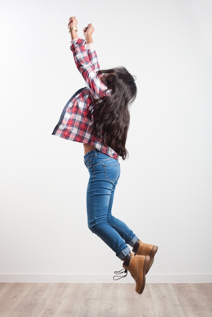 Girl jumping on her side with outstretched arms