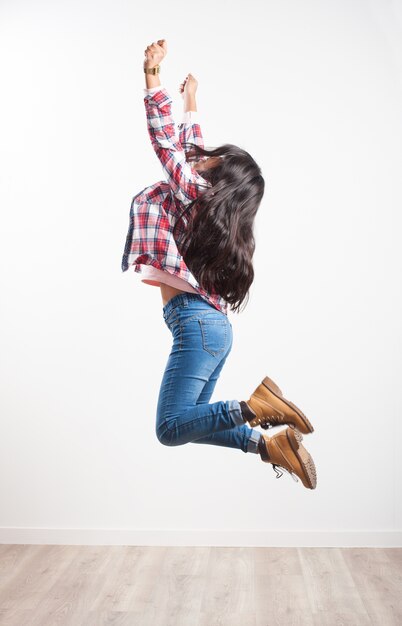 Girl jumping on her side with outstretched arms