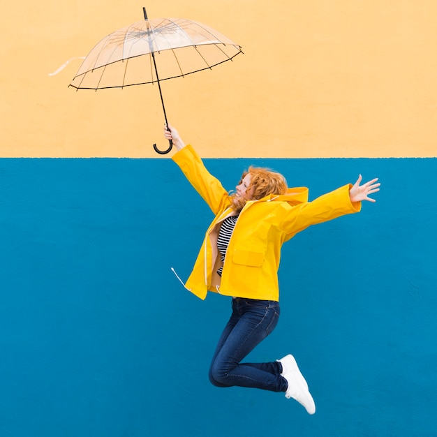 Girl jumping with umbrella