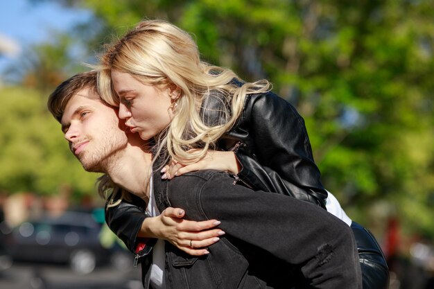 A girl kissing her boyfriend at the park High quality photo