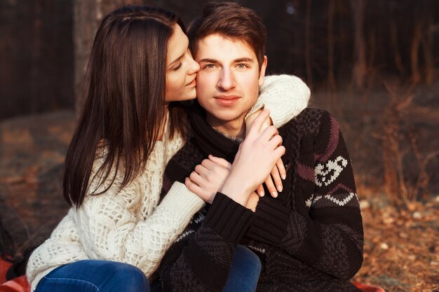 Girl kissing her boyfriend's cheek