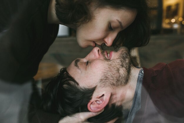 Girl kissing her boyfriend's nose