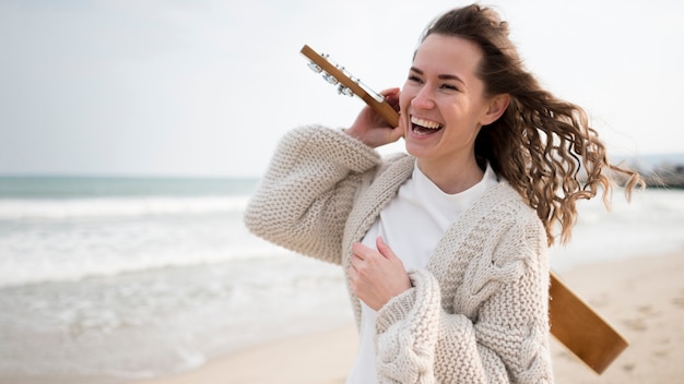 Girl laughing and holding a guitar