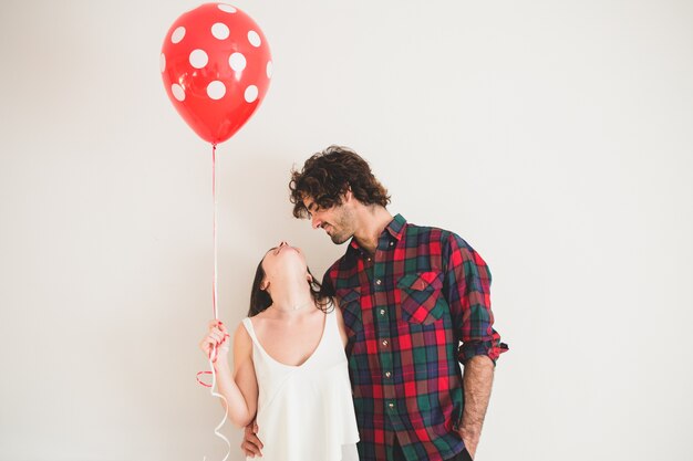 Girl laughing and looking up while her boyfriend looks at her