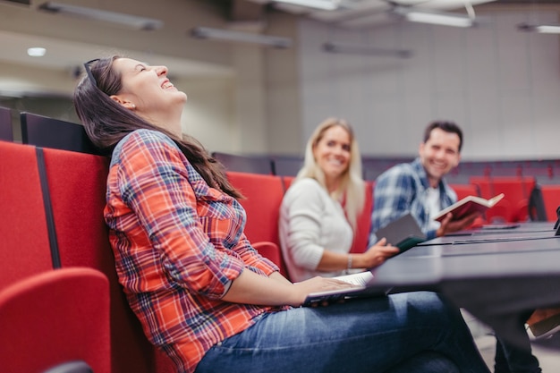 Girl laughing with friends in university