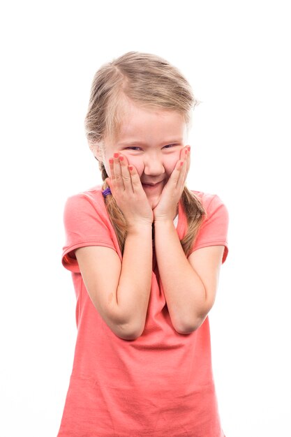 Girl laughing with hands over mouth