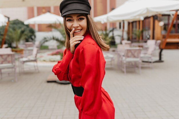 girl laughs wholeheartedly, . female portrait outside of model in adorable outfit