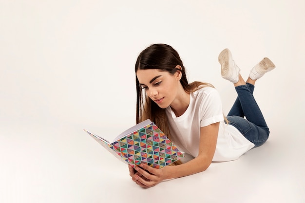 Girl laying down and reading