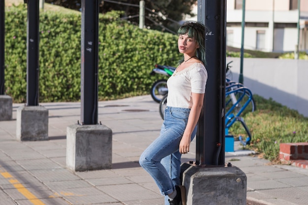 Girl leaning on pillar