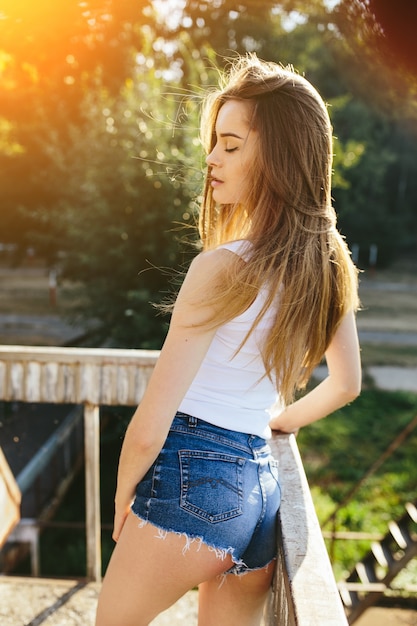 Free photo girl leaning on a railing