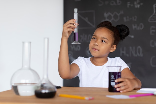 Girl learning more about chemistry in class