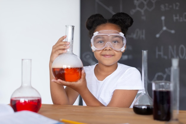 Free photo girl learning more about chemistry in class