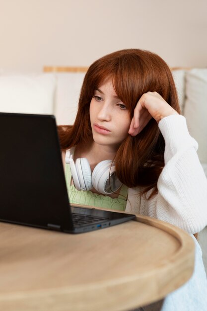 Girl learning with laptop and headphones