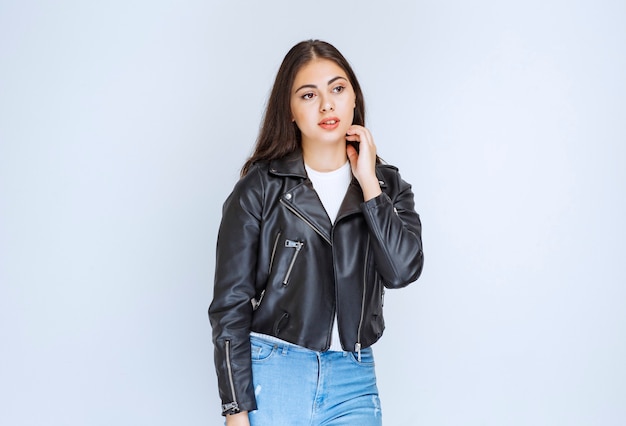 Girl in leather jacket giving neutral and relaxed poses. 