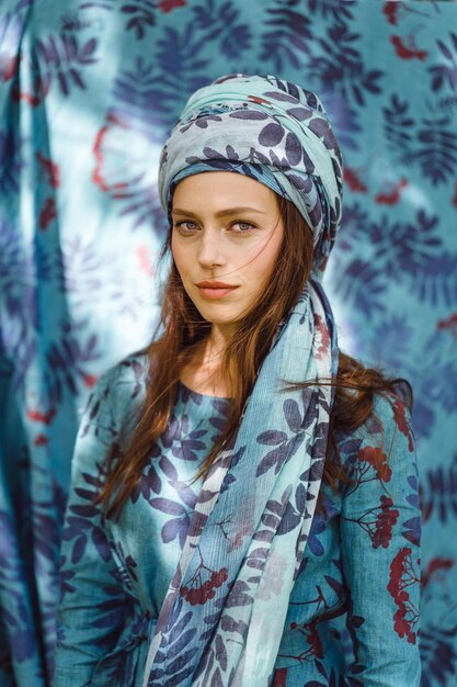 girl in a linen dress. with a wreath of flowers on her head.