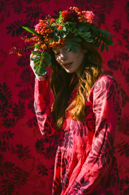 girl in a linen dress. with a wreath of flowers on her head.