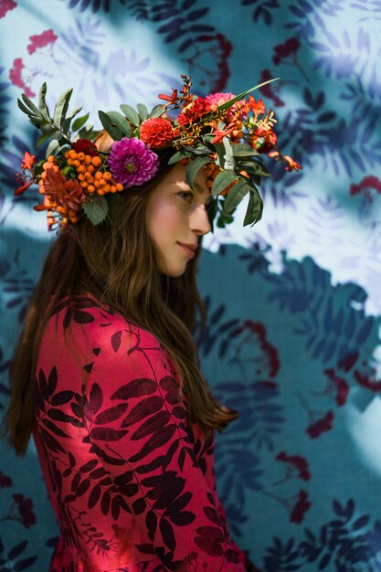 girl in a linen dress. with a wreath of flowers on her head.