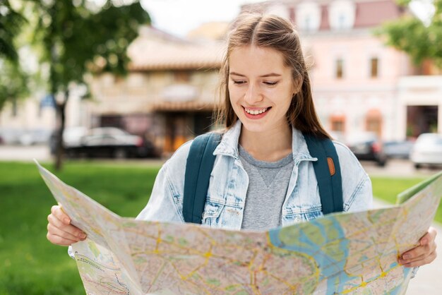 Girl looking at a map front view