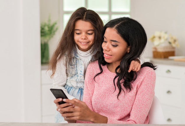 Free photo girl looking at mom mobile