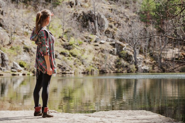 Girl looking at the river surface