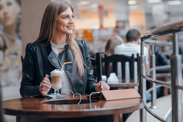 Girl looking to the side while holding a hand on a tablet