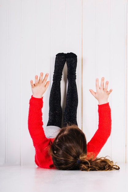 Girl lying on floor with legs up