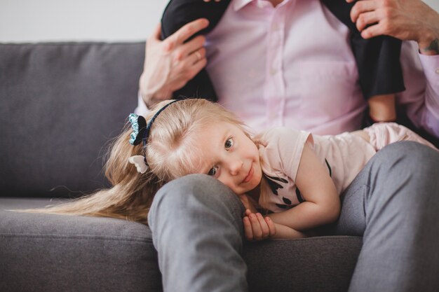 Girl lying on her father's legs