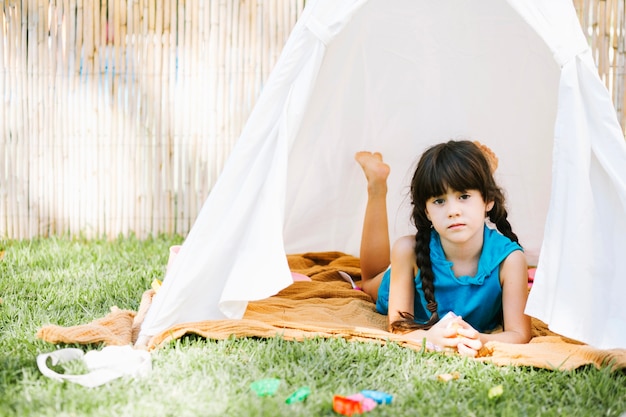 Girl lying in tent
