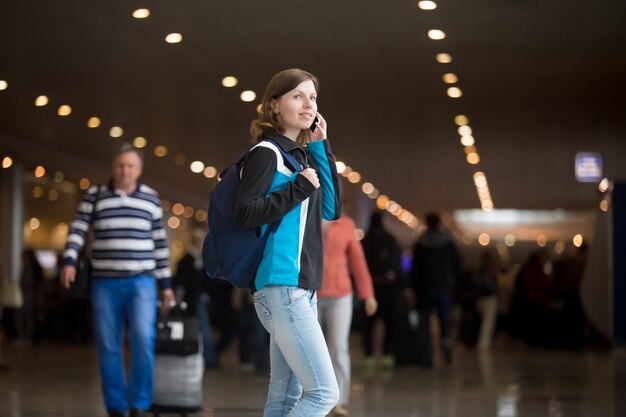 Girl making call in airport