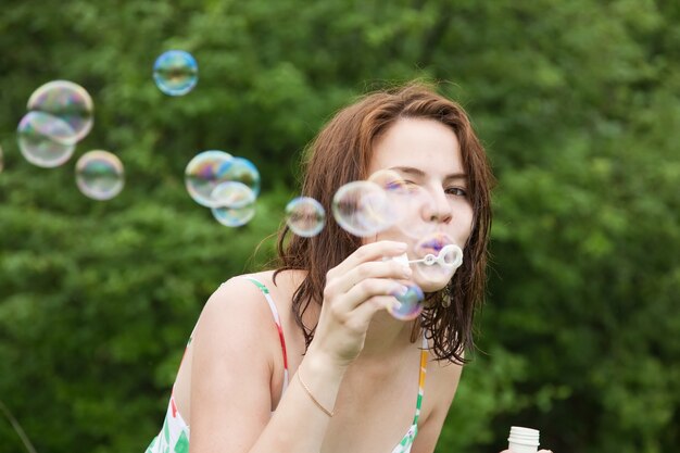 girl making soap bubbles