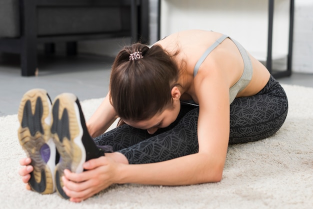 Girl making stretching in her house