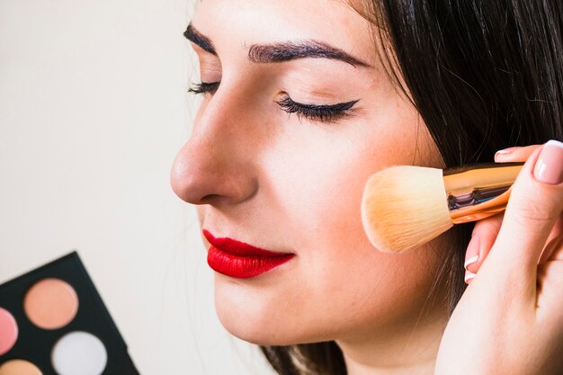 Girl making up her cheeks