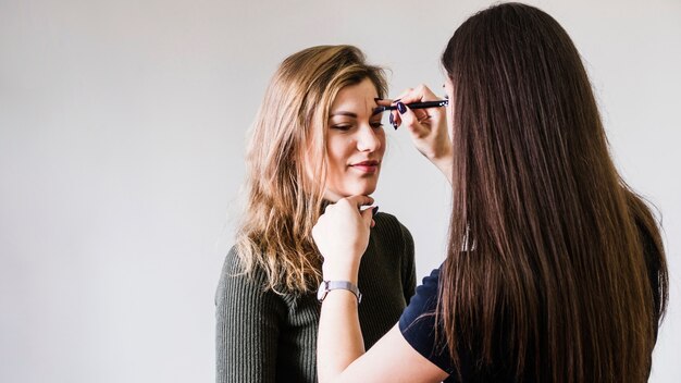 Girl making up her eyes