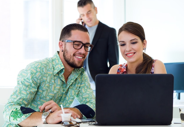 Girl and man looking at notebook's screen