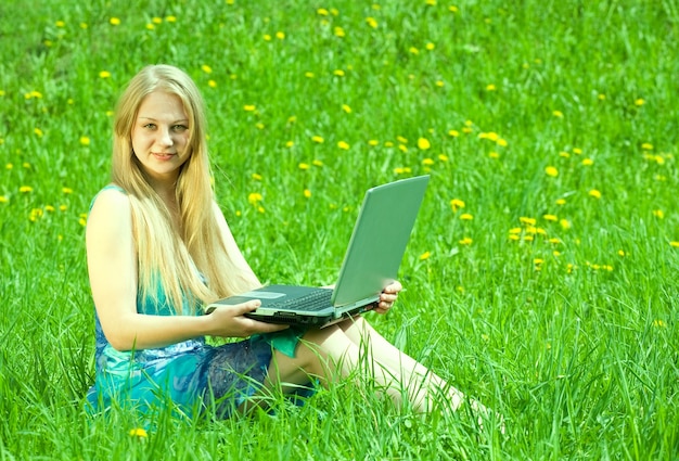 Free photo girl  on meadow with laptop