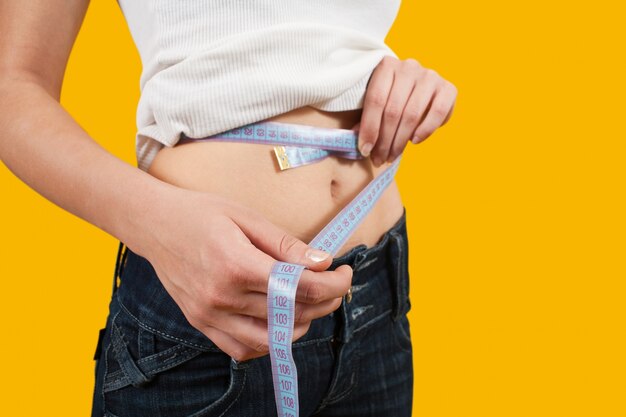 Girl measuring waist