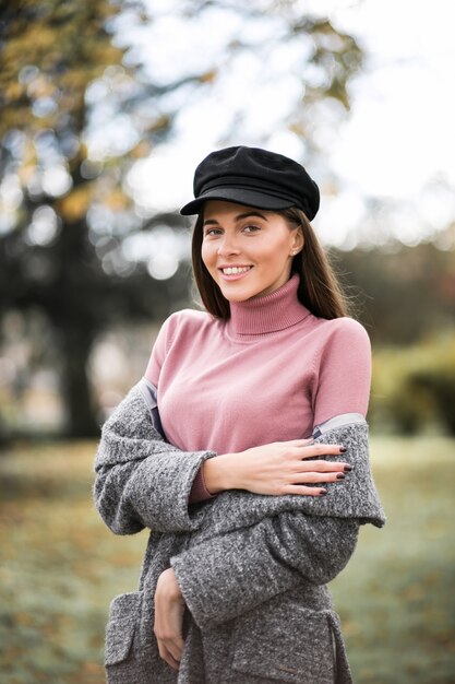 Girl in a newsboy cap in a park