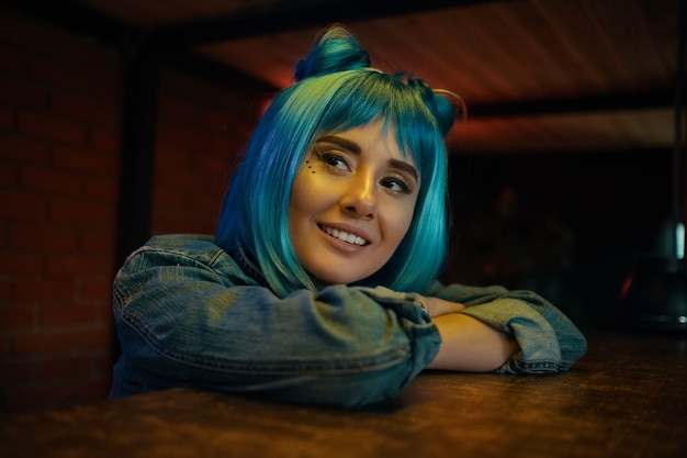 Girl in nightclub listening to to somebody while sitting at table