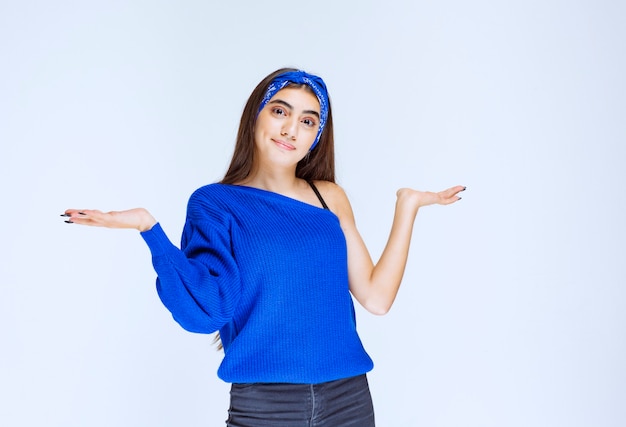 Girl opening both hands and presenting something.