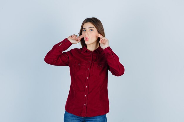 girl overhearing private conversation in casual shirt and looking surprised