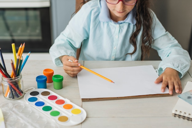 Girl painting with watercolor at home