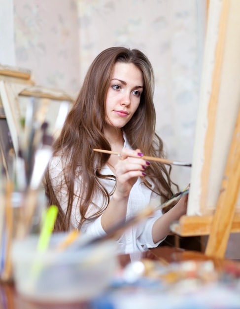 girl paints in workshop