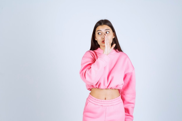 Girl in pink pajamas doing gossip