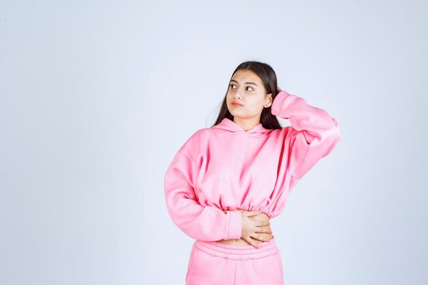 Girl in pink pajamas giving nasty and cheerful poses