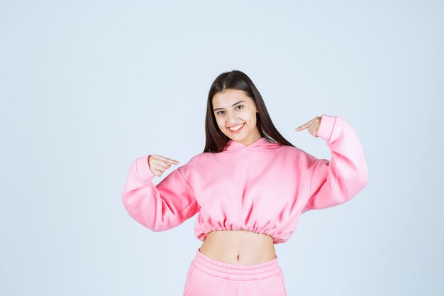 Girl in pink pajamas giving positive and nasty poses