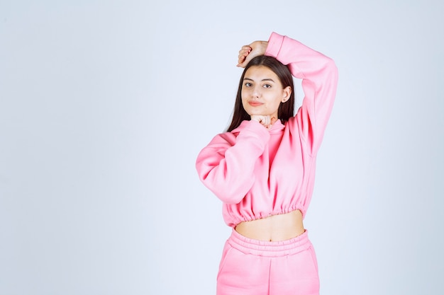 Girl in pink pajamas giving positive and nasty poses