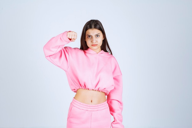 Girl in pink pajamas looks like a fighter and agressive